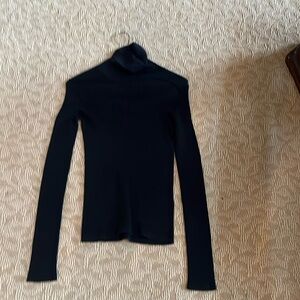 Woman’s black pants turtleneck ribbed sweater.